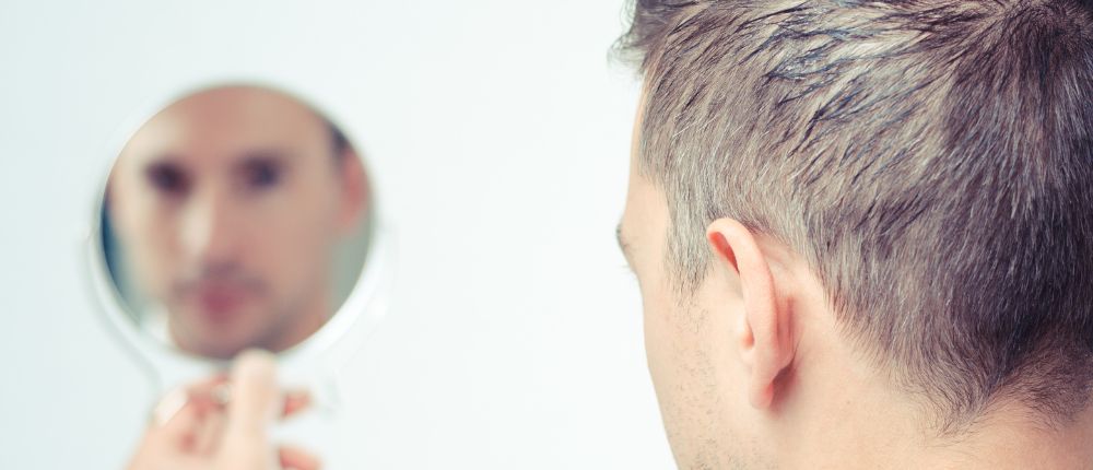 Man looking in the mirror to represent holding oneself accountable